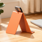 🥳🛋️✨ BEST-SELLER 2026 -50% ! Support de Téléphone Pliable en Silicone – Réglable, Antidérapant & Ultra-Mince (Noir/Orange)